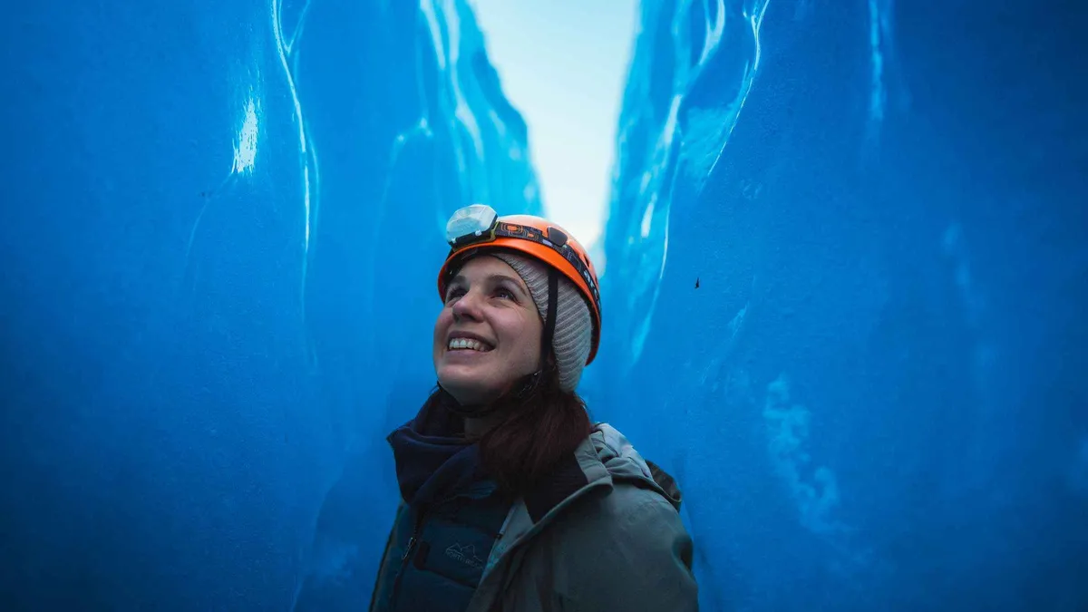 Small group roped up on the blue ice of Falljökull on a glacier hike below the Vatnajökull ice caves, Skaftafell, Iceland